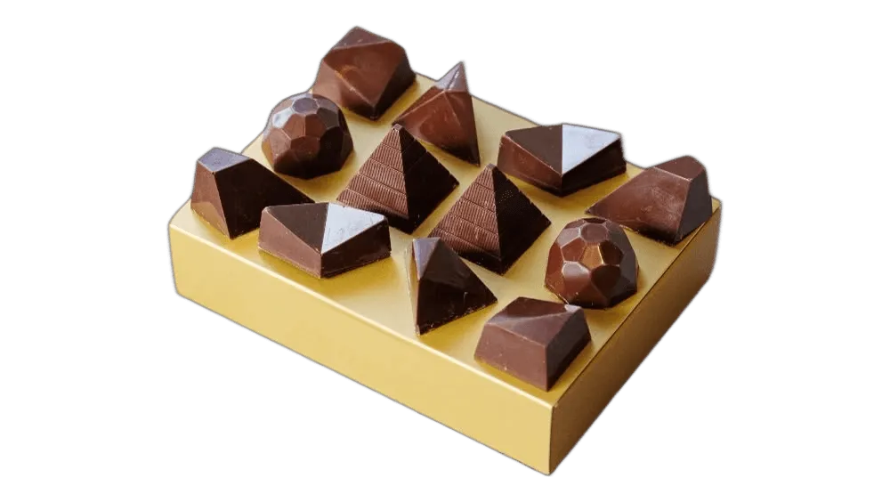 Twelve gem-shaped chocolate pralines on a golden box